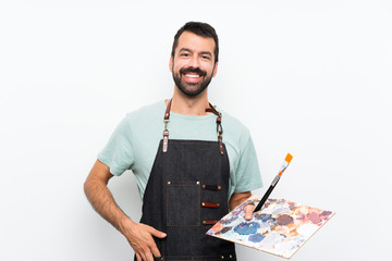 Young artist man holding a palette over isolated background laughing - obrazy, fototapety, plakaty