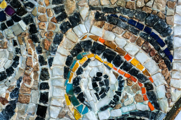 Fragment of the wall of small colored stones. Texture of stone. Beautiful natural colorful background. Blur, soft focus