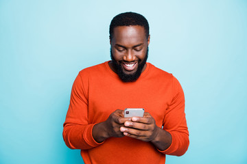 Photo of cheerful positive handsome man holding telephone smiling toothily searching information new isolated vivid blue color background - Powered by Adobe