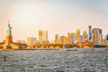 Statue of Liberty on Liberty Island on the background New York Harbor and New York City.