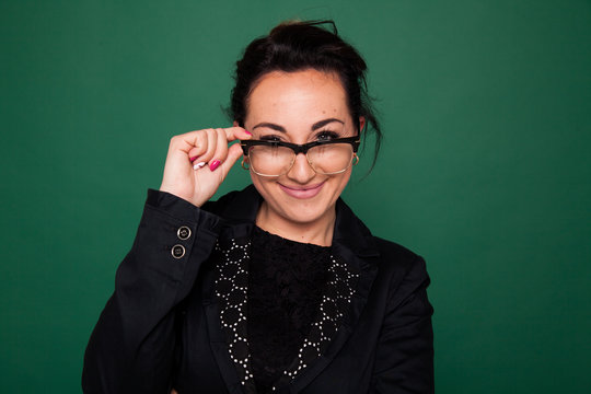 beautiful female teacher at the classroom board at school