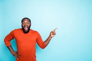 Photo of attractive dark skin business guy toothy smiling indicating finger to empty space advising...