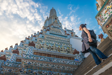 Traveler woman looking pagoda temple unique attractions in Wat Arun, Popular famous landmark travel Bangkok Thailand, Tourist female on holiday vacation trips, Tourism beautiful destination place Asia