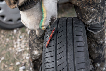 Fototapeta na wymiar Elimination of a puncture on a car wheel