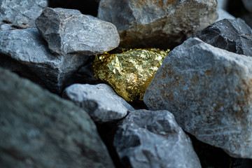 Naklejka na ściany i meble Gold nugget and grey granite stone