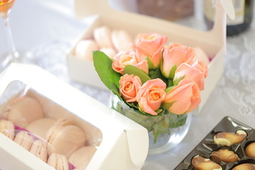 Fototapeta na wymiar Macarons dessert with pink roses flowers. Wedding ceremony.
