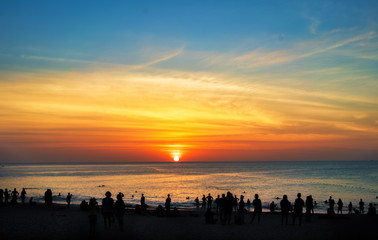 Silhouettes of people over sea background at sunset. Thailand, Phuket, Karon Beach