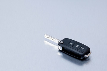 New remote vehicle key fob on aluminium background. Repair of broken or damaged remote key fob of any vehicle car service.- Image