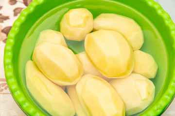 Peeled potatoes for frying in a cup