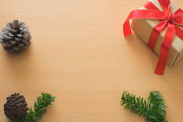 Christmas background with gift boxes, pine cone and decorations on wood board. Preparation for holidays. Top view with copy space.