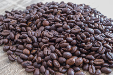 Coffee beans on wooden background with copyspace left.