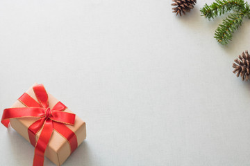 Christmas background with gift boxes, pine cone and decorations on light blue background. Preparation for holidays. Top view with copy space.