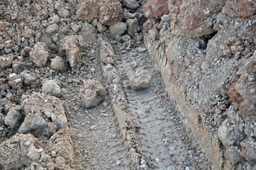 Truck tire tread marks on the ground.