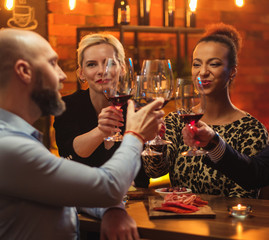 Group of friends having fun talk behind bar counter in a cafe