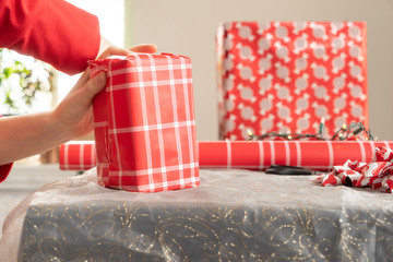She is having something of a difficult time making her wrap job nice and neat on this one present...