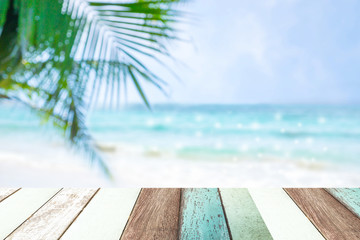 Paint wood with blur of beautiful view of  blue sea and white beach and coconut leaves.