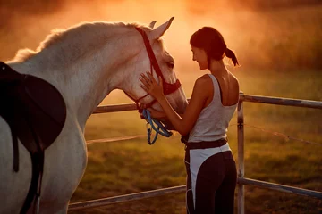 Fotobehang Girl with hourse. Woman and her horse on a sunset. © luckybusiness