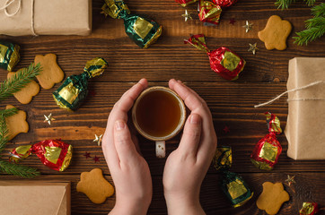 flatlay woman with cup of tea, sweets and gifts
