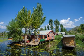 Fototapeta na wymiar View of houseboat at Dal Lake in Kashmir, India. Since 1947 the ownership of Kashmir has been disputed between Pakistan and India.