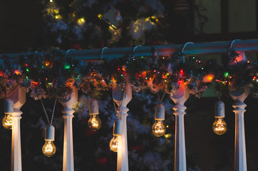 Christmas decorations and lights hanging on a porch