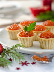 tartlets with red caviar on plate
