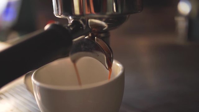 Coffee Maker Pouring Hot Espresso Coffee In A Cup in Slow Motion