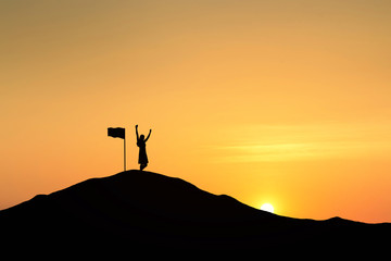 Silhouette of people and flag on top mountain, sky and sun light background. Business success and goal concept. © cofficevit