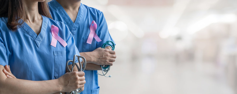 Breast cancer awareness pink ribbon raising awareness on woman health and female illness in October month with bow color on male and female surgical doctor gown in clinic or hospital