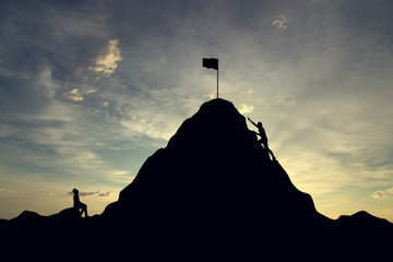 Silhouette of successful team and team that failed at sunset background.