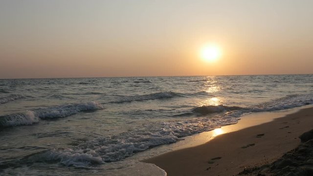Sunrise over the blue Aegean sea waves and beach 4K video