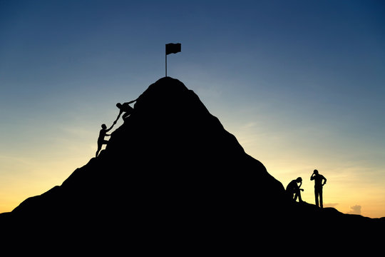 Silhouette of successful team and team that failed at sunset background.