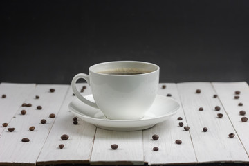  expresso coffee in a white mug on a white wooden background coffee beans around sugar and sweet spot for inscription