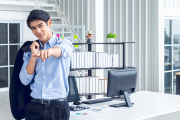 Young Asian Businessperson is standing smart poses and smile at co working space decorated in...