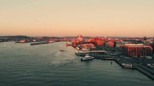Aerial over the Gota alv river in Gothenburg at dusk. Drone slow forward dolly