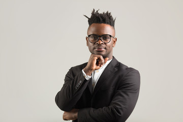 handsome young african man in black suit wearing glasses