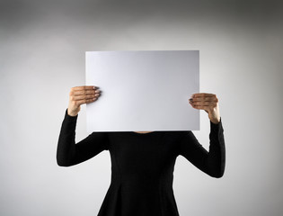 Young attractive woman is holding white paper.