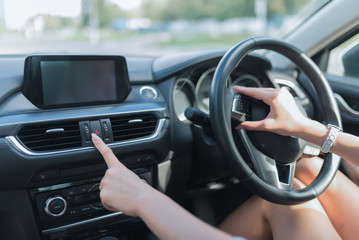 Close-up, woman in car, clicks on emergency stop button. Safety on road on city, activation of alarm signal, emergency essence, problem on road, warning drivers. Right-hand drive, left-hand drive.