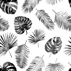 Seamless hand drawn pattern with black palm leaves on white background. Vector