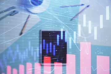 Double exposure of forex graph on digital tablet laying on table background. Concept of market analysis