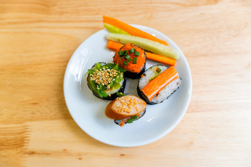Rice Sushi is a lump of meat on white plate put on wood table  and eaten with sauce in Japanese food restaurant is a popular dish in Thailand