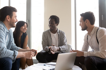 Diverse employees team discussing strategy, sharing startup ideas at briefing