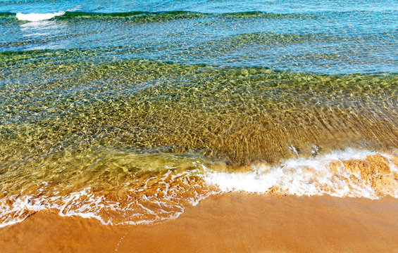 Gournes, Heraklion, Crete, Greece. October 2019. Colourful sea with waves breaking on the Ambrosia Beach at Gournes.
