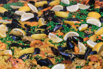 Traditional spanish seafood large paella cooking food background