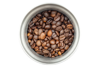 Steel coffee grinder filled with coffee beans isolated on white background. Top view