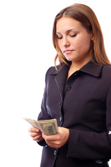 A young woman with dollars in her hands, isolated on white background