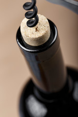bottle of wine with a corkscrew