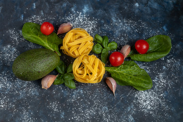 Ingredients for cooking Italian pasta. Pasta, basil, cheese, cherry tomatoes, olive oil, egg, yolk. On a light background. Copy space. 