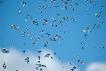 Blue water drops on blue sky background