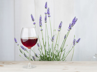 Glass of wine with lavender bush.