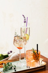 Prosecco cocktail, aperitif with Prosecco a white sparkling italian wine, bitter, thyme and juniper berries; Prosecco, lime and lavender; and Prosecco, orange and rosemary